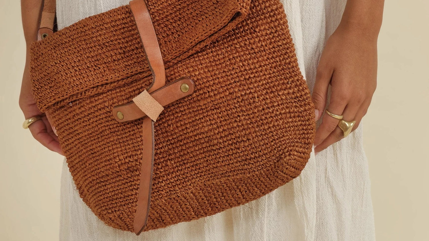 light brown woven shoulder bag with leather detail